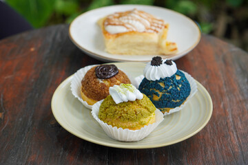 Sweet assorted pastries with colorful cream puffs, soft airy texture, creamy rich filling, and delightful dessert flavor, modern caf&eacute; style presentation with inviting visuals and appetizing charm