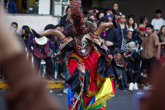 Diablada dancer performing traditional ecuadorian folklore costume parade