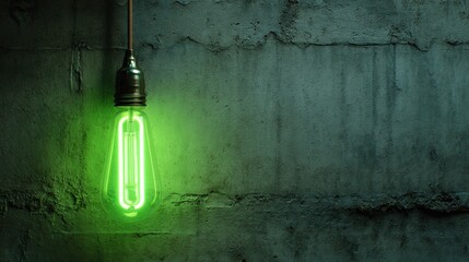 Green, glowing bulb hangs against rough concrete wall, suspended by a wire, emitting an eerie light