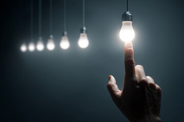 Human finger activating a glowing light, symbolizing ideas, inspiration, and moments of realization.