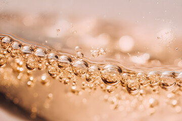 Bubbles rising in sparkling beverage close-up photography warm lighting abstract concept
