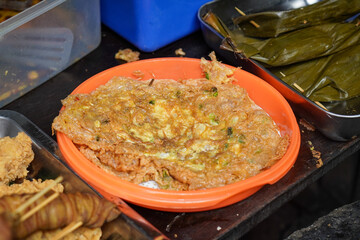 Assorted traditional Indonesian dishes with vibrant homemade flavors, mixed vegetables, fried fish, savory side dishes, and rustic market-style presentation, rich cultural culinary visuals