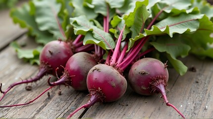 Four whole purplish-red beets placed close together