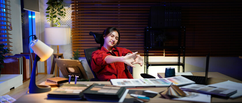 Tired female architect designer in chair at workplace sleep or nap after long day, businesswoman stretching arms while working at desk work overtime, peace, stress free concept - Powered by Adobe