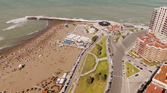 Iconic Torreon del Monje building and Las Toscas beach resort area. Tourists enjoy summer vacation on the coast. Crane down aerial view
