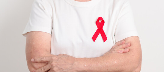 Elderly with Red Ribbon for December World Aids Day, MADD, October Red ribbon week, February Heart month, Marfan Syndrome, May Stroke awareness, March world TB Tuberculosis day and April Dare day