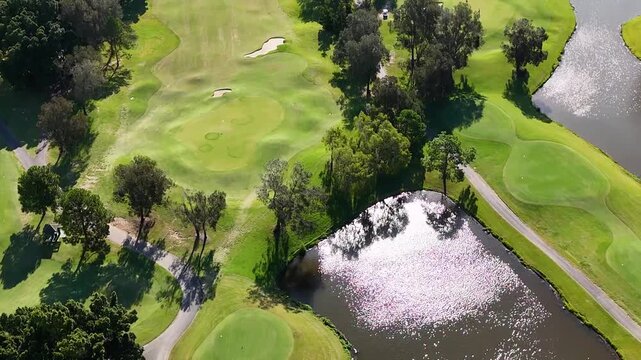 Aerial View of Lush Golf Course Fairways and Sparkling Water Hazards