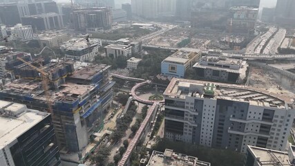 Drone perspective of a crowded metropolitan area with repeating building patterns and infrastructure networks, highlighting large-scale urbanization.