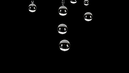 Close-up of clear, spherical water droplets suspended against a stark black background, reflecting light.