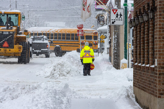Canada, Quebec, 11 November 2025 : Winter school crossing guard ensures safe passage amid heavy snowfall.