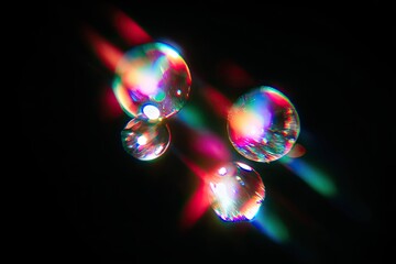 Close-up of water droplets with rainbow light refraction against a dark background