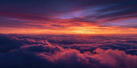 Fototapeta premium Stunning vista of vibrant, colorful sunset over a fluffy cloud sea