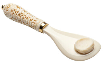 Vintage carved cosmetic spatula holding white face cream on a transparent background