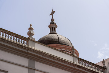Cathedral dome with cross above rooftop balustrade, architectural detail in La Laguna, San Cristobal de La Laguna, Tenerife.