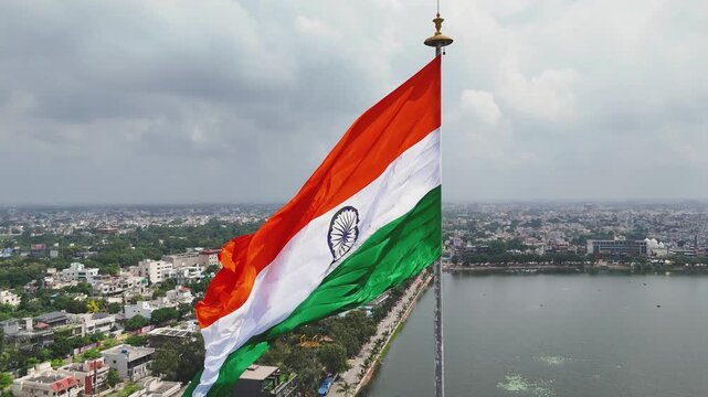Indian Flag Over Raipur City, Tiranga Flying Above Marine Lake, National Flag Aerial City View, Patriotic Tricolor Over Urban India, Indian Flag Republic Day Drone Shot Stock Video.