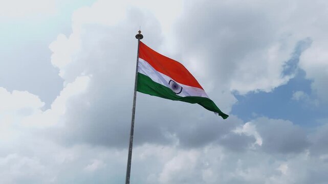 Indian Flag Against Blue Sky, Tricolor Waving in Cloudy Sky, National Flag Freedom Concept, Patriotic Indian Flag Outdoors, Tiranga Flying High Stock Video.
