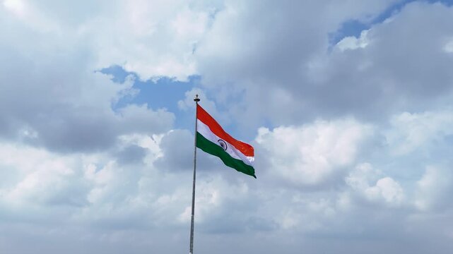 Indian Flag Against Blue Sky, Tricolor Waving in Cloudy Sky, National Flag Freedom Concept, Patriotic Indian Flag Outdoors, Tiranga Flying High Stock Video.