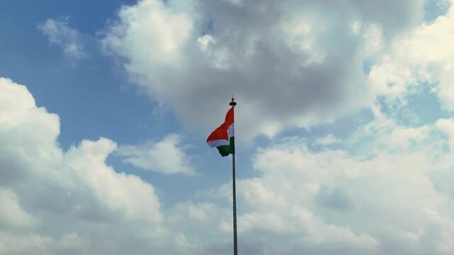 Indian Flag Against Blue Sky, Tricolor Waving in Cloudy Sky, National Flag Freedom Concept, Patriotic Indian Flag Outdoors, Tiranga Flying High Stock Video.