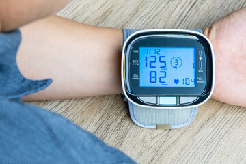 Man check blood pressure monitor and heart rate monitor with digital pressure gauge. Health care and Medical concept	