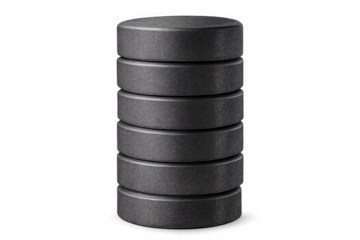 Stack of black ice hockey pucks made of vulcanized rubber, forming a vertical column. Sports equipment for competition