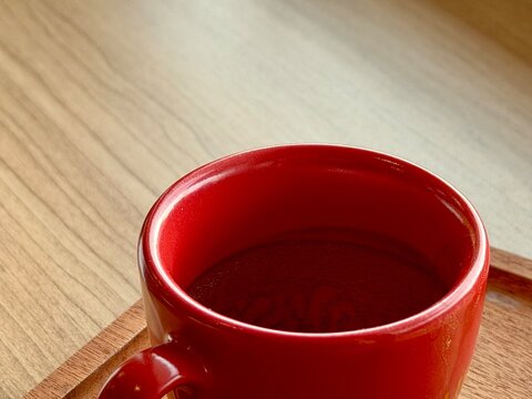 Empty red espresso glass with coffee stains inside. BSD, Indonesia - January 5, 2025
