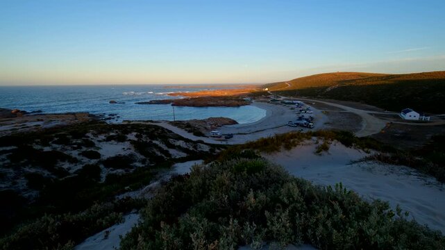 Twilight colors of moonset at dawn viewed from dune in Cape Columbine reserve