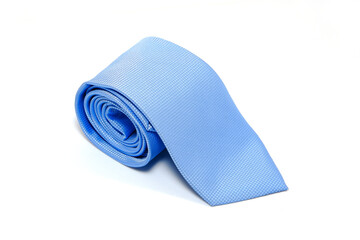 Elegant blue textured tie rolled isolated on white background for professional fashion concept closeup shot 
