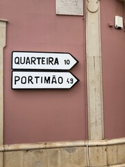 Fototapeta premium Portuguese Directional Street Signs Pointing to Quarteira and Portimão in Algarve, Portugal