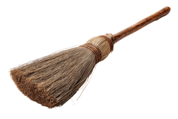 Rustic broom with wooden handle on a dark background