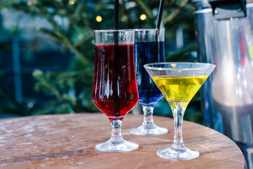 Assorted Colorful Fruit Cocktails with Straws and Garnish on a Bar Counter