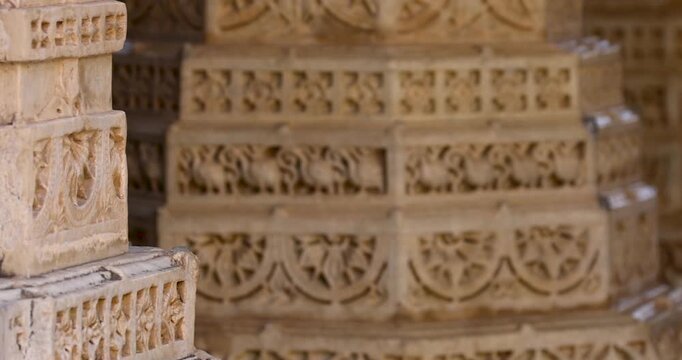 Intricate architecture on the large pillars of historic Jain temple in Ranakpur village , Rajasthan, India. Built in 1496