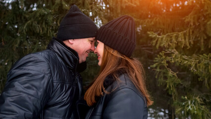 Intimate Moment Beneath Trees, Closeup Of Lovers In Wintry Forest Scene Conveying Warmth And Affection, An Affectionate Couple Resting Their Foreheads Together Beneath Fir Branches In Chilly Air