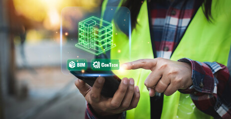 Engineer using smartphone for ConTech and BIM construction technology to manage smart building projects and infrastructure innovation