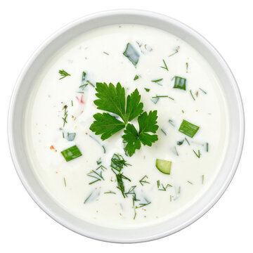 Creamy chalap cold soup with a blend of fresh herbs and vegetables, in a transparent glass and isolated on a white background