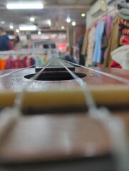 Musical Instrument Fretboard in a Blurred Clothing Store