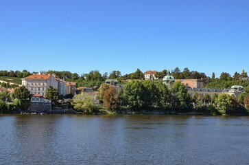 Fototapeta premium the Vltava River and behind it historic buildings in Prague