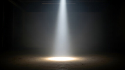 A bright white spotlight illuminates a dark, textured stage floor, creating a dramatic and atmospheric scene