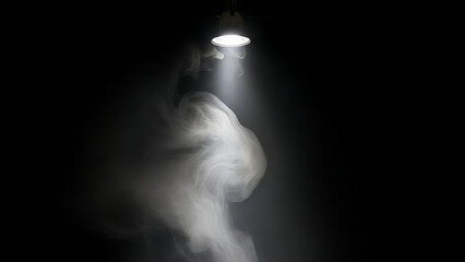 Mysterious white smoke or fog illuminated by a spotlight in a dark room
