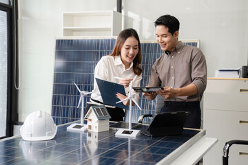 Architect team working with blueprints for sketching a construction project, green energy and solar...