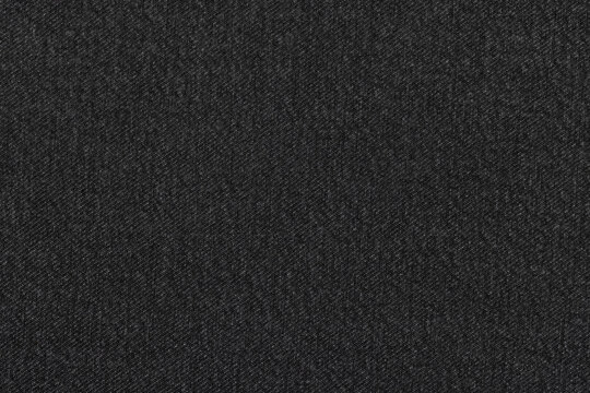 Dark-colored denim, for jackets, jeans and other clothing, close-up. Background, texture