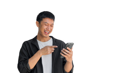 An Asian man wearing a black jacket is happily playing on his mobile phone against isolated on a white background. Laughter is evident from using social media.