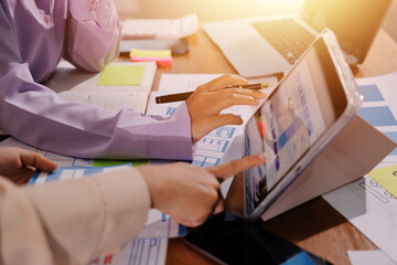 Close up ux developer and ui designer brainstorming about mobile app interface wireframe design on table with customer breif and color code at modern office.Creative digital development agency.