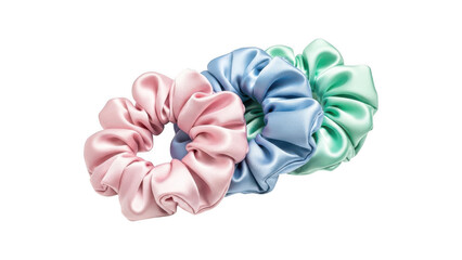 Three colorful silk scrunchies in pink, blue, and green hues isolated on transparent background