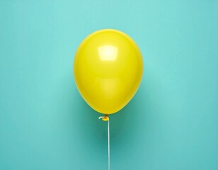 Single Yellow Balloon Floating on Minimalist Teal Blue Background with Copy Space