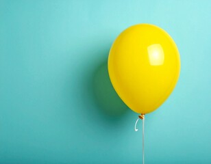 Single Yellow Balloon Floating on Minimalist Teal Blue Background with Copy Space