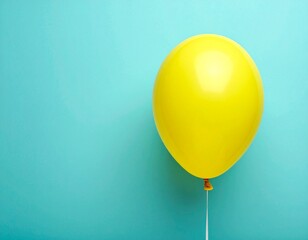 Single Yellow Balloon Floating on Minimalist Teal Blue Background with Copy Space