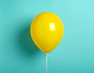 Single Yellow Balloon Floating on Minimalist Teal Blue Background with Copy Space