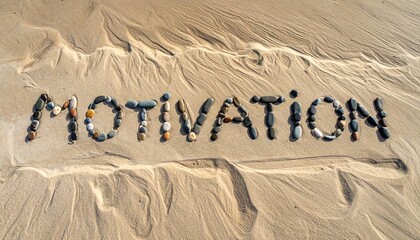 Artistic shot of the word motivation formed with stones on the sand at a beach