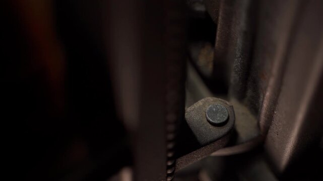 Door hinge holding the fireplace stove door, close-up