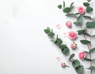 Minimalist Eucalyptus Branches and Pink Roses Flat Lay on White Background with Copy Space
